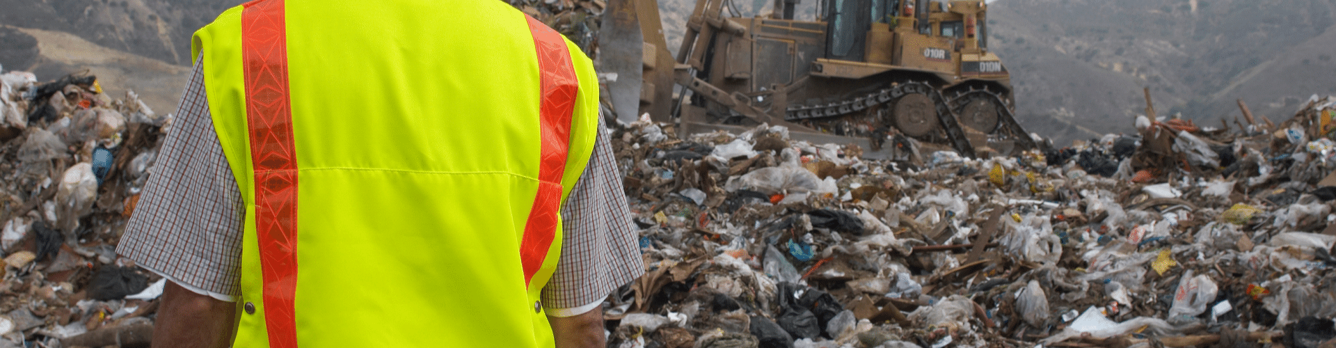man in hi-vis jacket at a landfill site