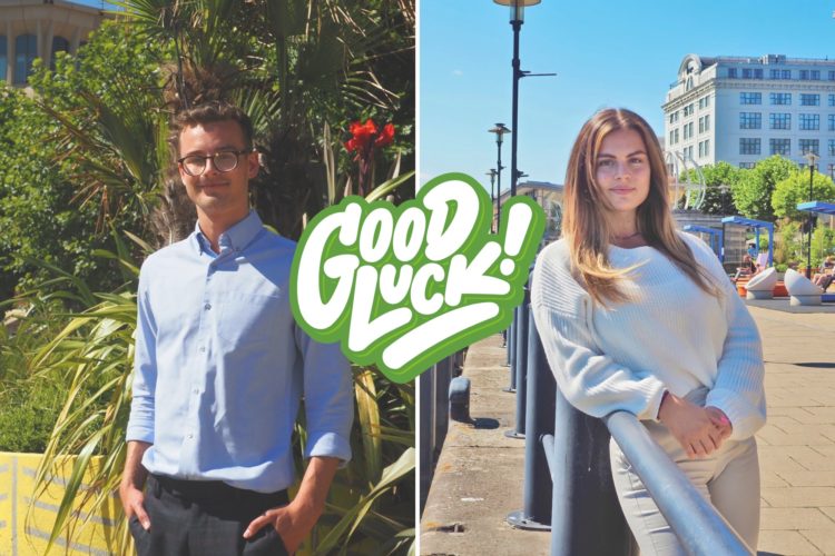 Tom stands on the left behind some green plants, Rosie stands on the left in front of a path next to the River Tyne and is leaning against a railing. A sticker is in the front of the image saying 'good luck!'